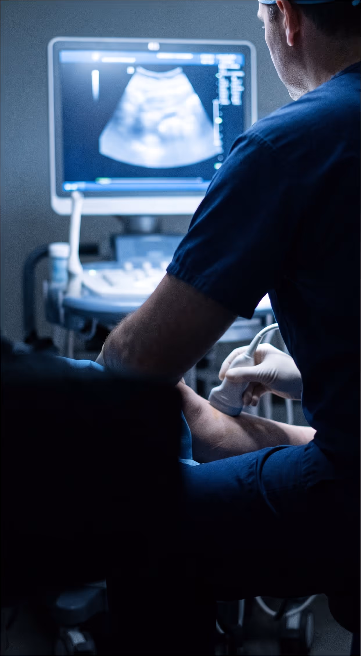 Clinician performing a duplex ultrasound scan on a patient's leg